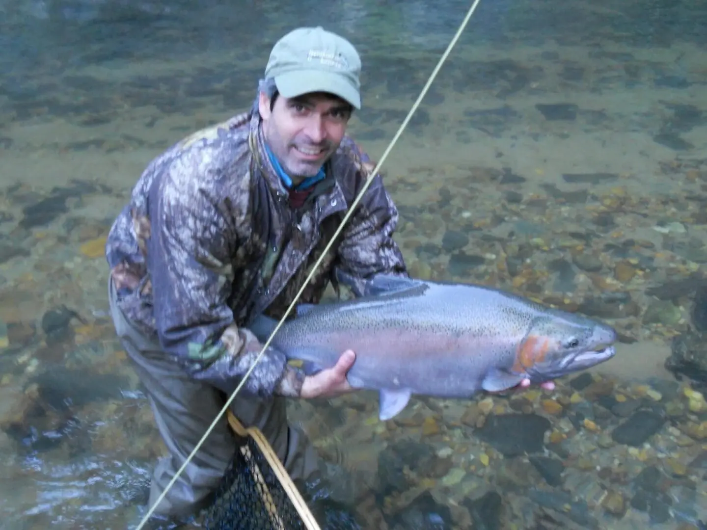 Fisherman Holding a Big Fish From the River